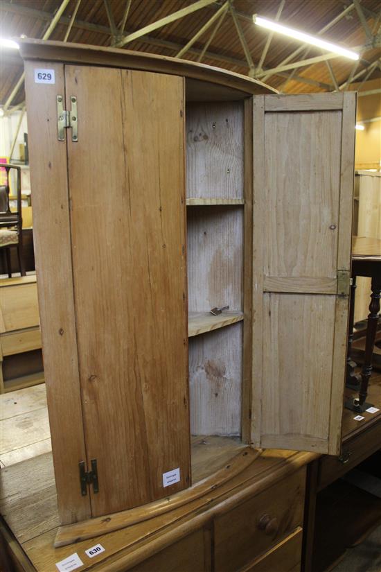 Early 19th century pine bowfronted hanging corner cupboard